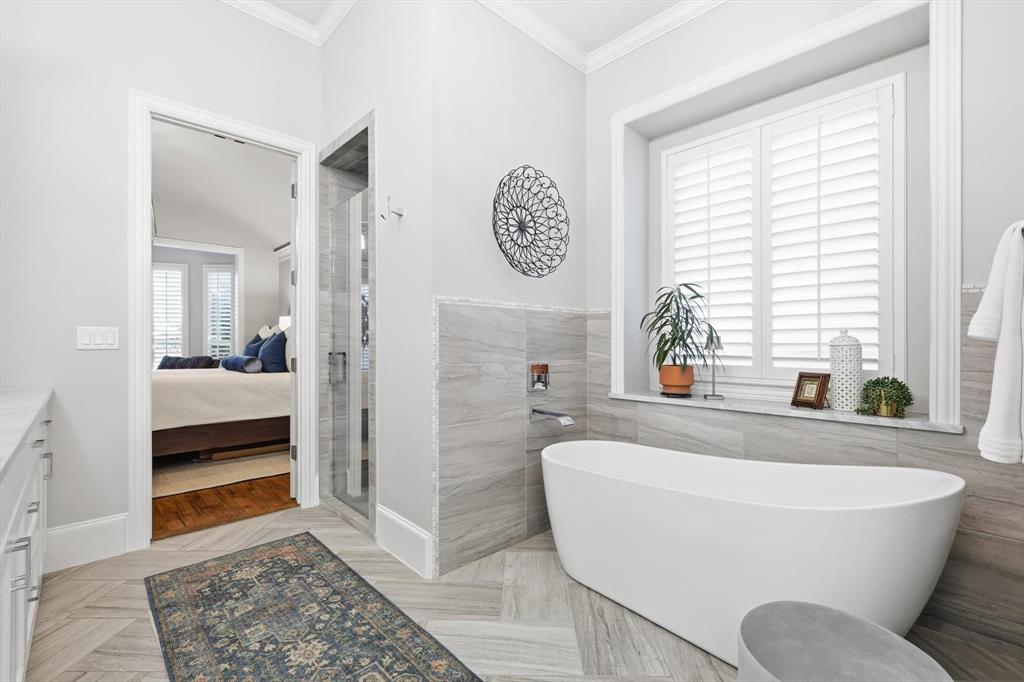 921 Winding Ridge Trail Southlake, TX 76092 - Photo 22 of 40 a spacious bathroom with a bathtub and a window