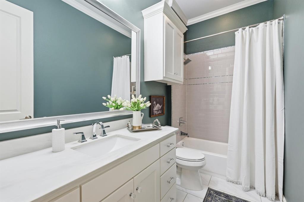 921 Winding Ridge Trail Southlake, TX 76092 - Photo 25 of 40 a bathroom with a granite countertop sink toilet a mirror and shower