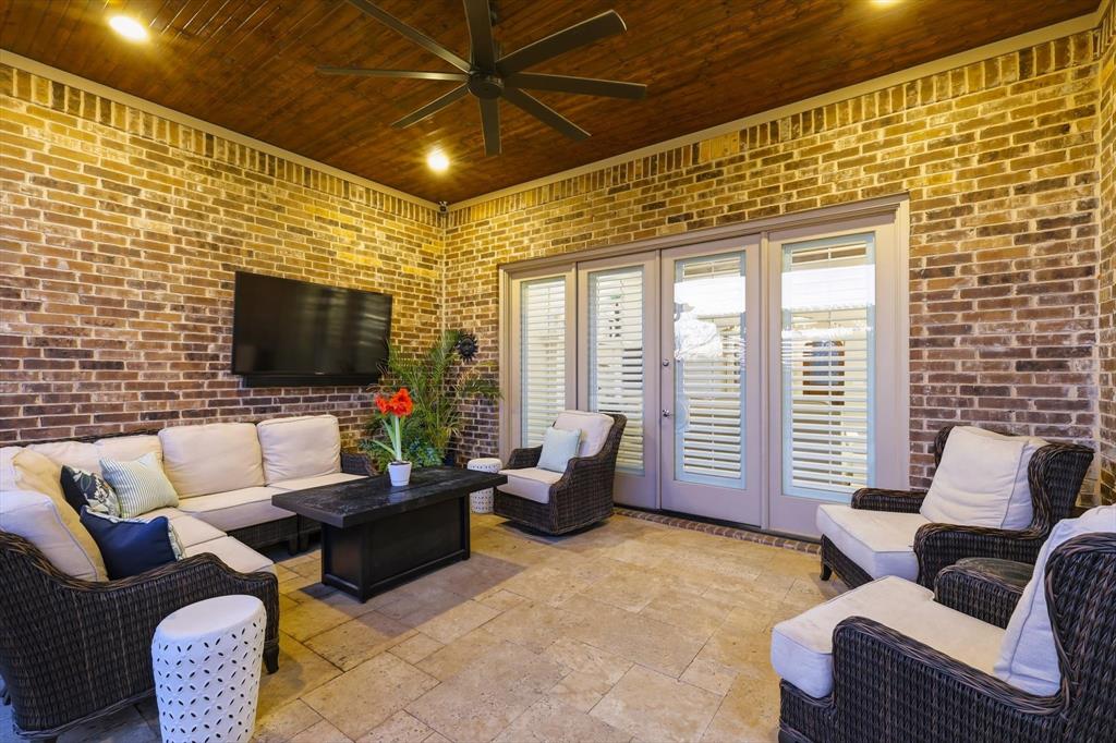 921 Winding Ridge Trail Southlake, TX 76092 - Photo 28 of 40 a living room with furniture floor to ceiling window and a flat screen tv
