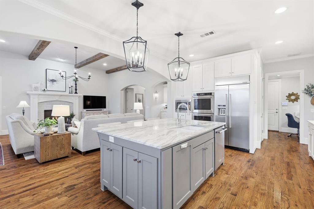 921 Winding Ridge Trail Southlake, TX 76092 - Photo 8 of 40 an open kitchen with a sink stove and refrigerator