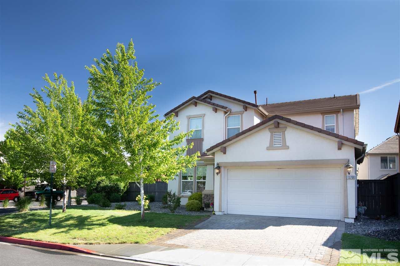 13700 Seabiscuit Drive Reno, NV 89521 - Photo 1 of 27 a view of a white house next to a yard with big trees