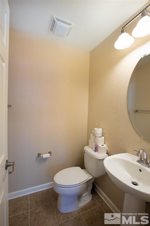 13700 Seabiscuit Drive Reno, NV 89521 - Photo 15 of 27 a bathroom with a sink mirror and toilet