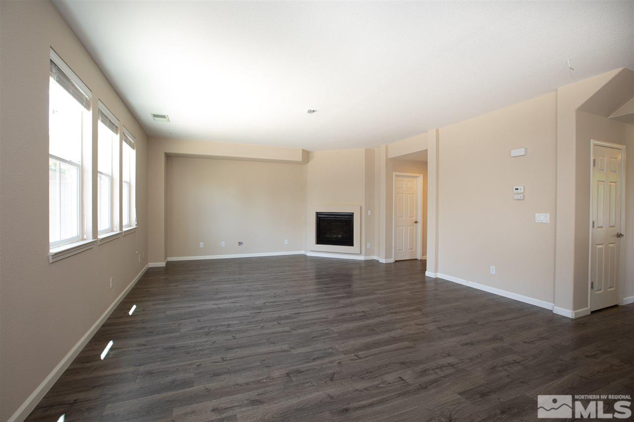13700 Seabiscuit Drive Reno, NV 89521 - Photo 10 of 27 a view of an empty room with wooden floor and a window