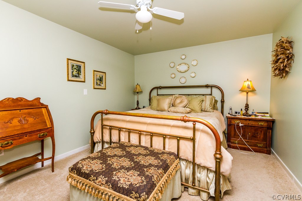 4945 Newbys Bridge Road Chesterfield, VA 23832 - Photo 14 of 22 a bedroom with a bed and wooden floor