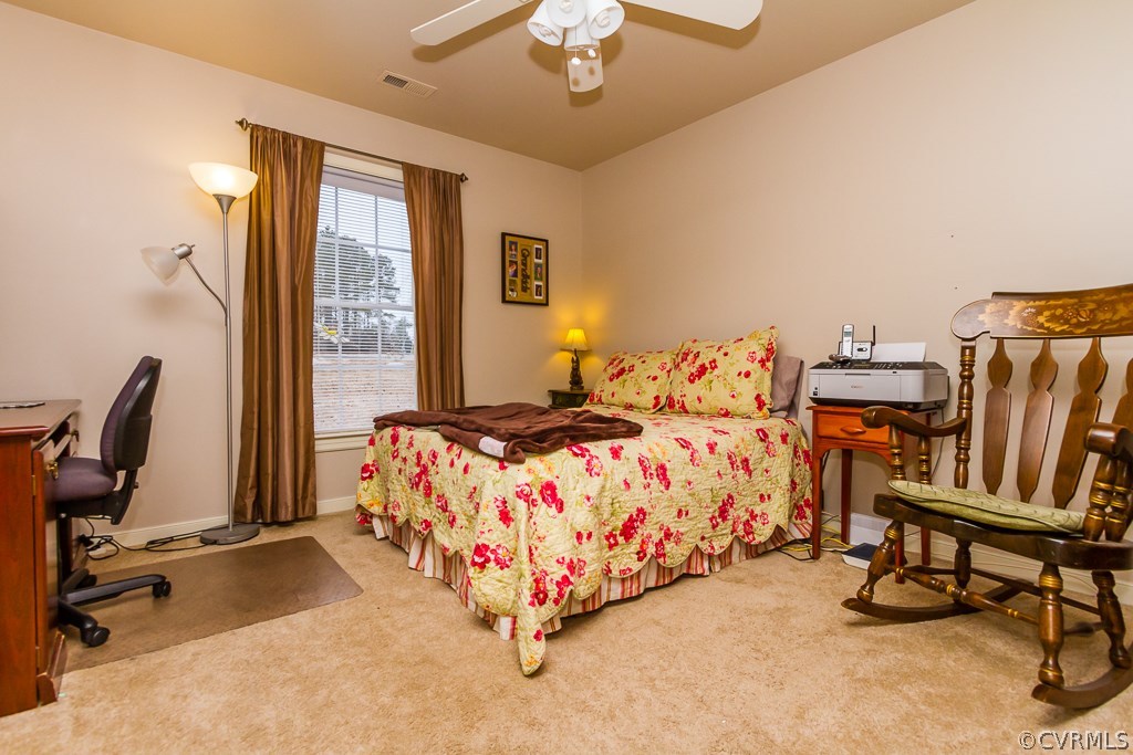 4945 Newbys Bridge Road Chesterfield, VA 23832 - Photo 20 of 22 a bed sitting in a bedroom next to a window