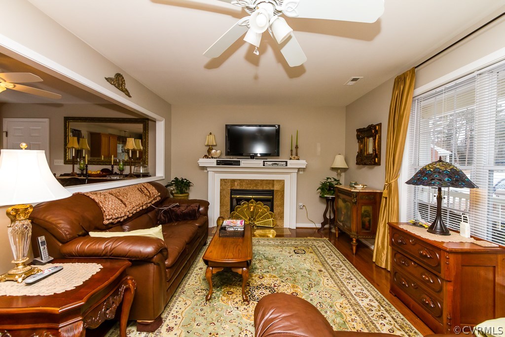 4945 Newbys Bridge Road Chesterfield, VA 23832 - Photo 8 of 22 a living room with furniture a fireplace and a flat screen tv