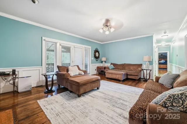 a living room with furniture fireplace and flat screen tv