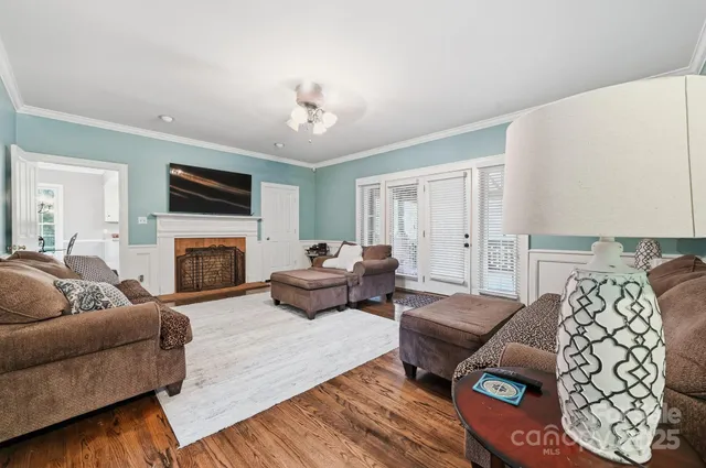 a dining room with furniture a rug and a chandelier