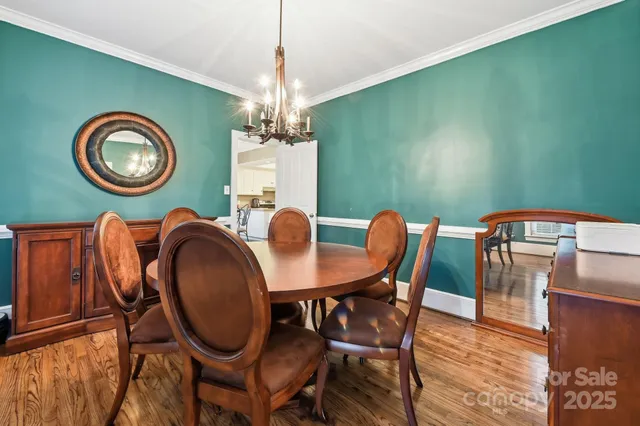 a view of a dining room with furniture and a chandelier