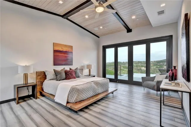 a bedroom with a bed and a large window