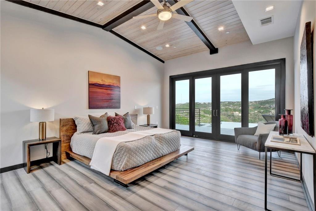600 Barrett Lane Austin, TX 78733 - Photo 16 of 35 a bedroom with a bed and a large window
