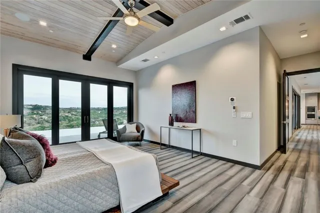 a bedroom with a bed and a large window