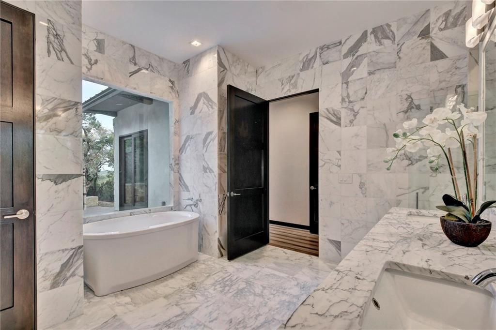 600 Barrett Lane Austin, TX 78733 - Photo 19 of 35 a bathroom with a tub shower and sink