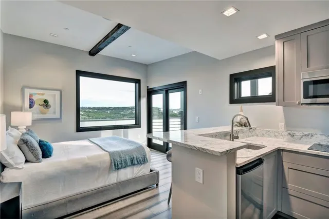 a bedroom with a bed window and table