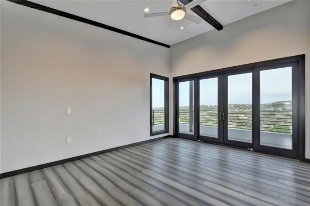 wooden floor in an empty room with a window