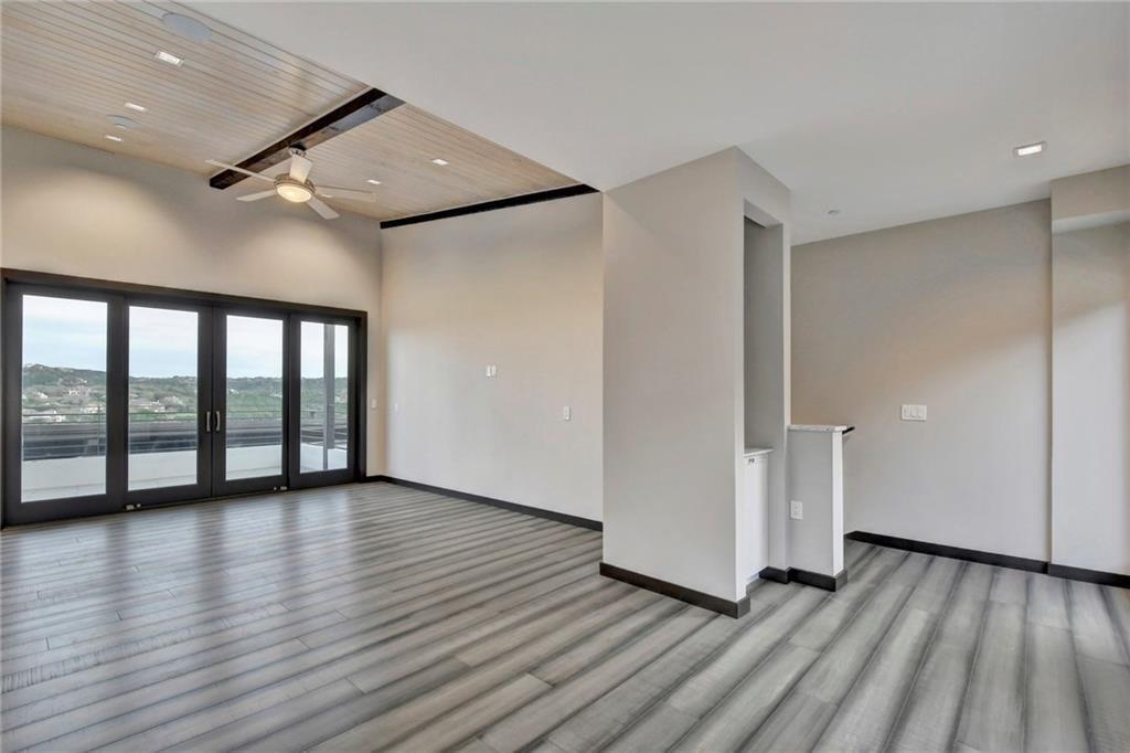 600 Barrett Lane Austin, TX 78733 - Photo 24 of 35 a view of an empty room with wooden floor and a window