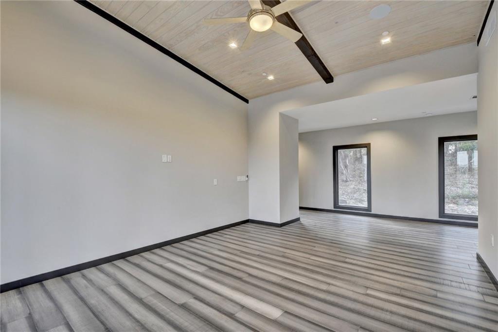 600 Barrett Lane Austin, TX 78733 - Photo 26 of 35 an empty room with wooden floor and windows