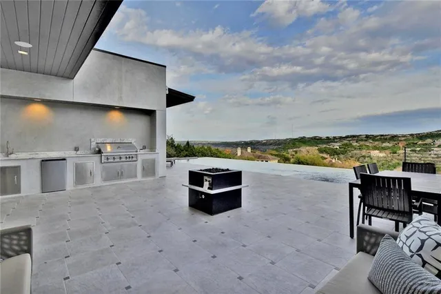 a terrace with outdoor seating and city view