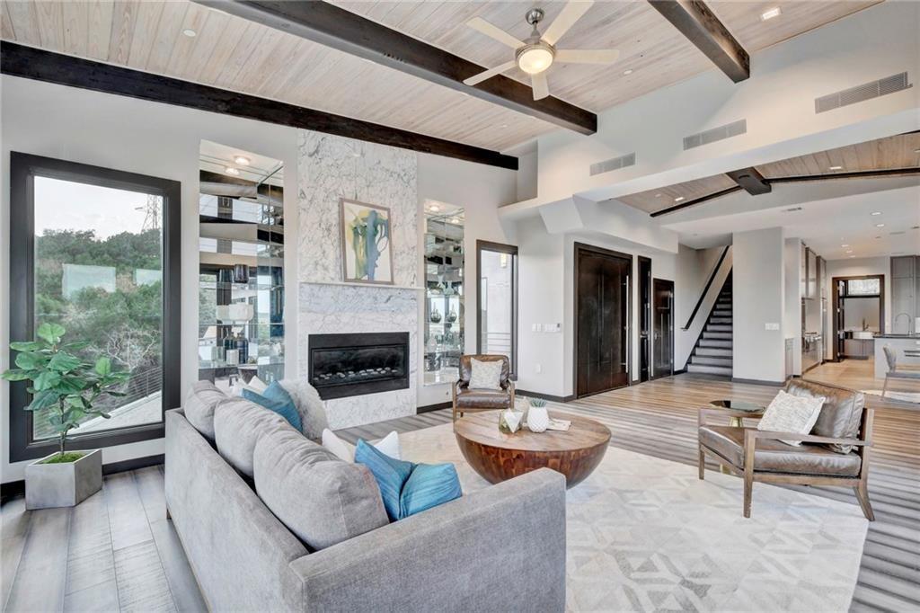 600 Barrett Lane Austin, TX 78733 - Photo 3 of 35 a living room with furniture large window and a fireplace