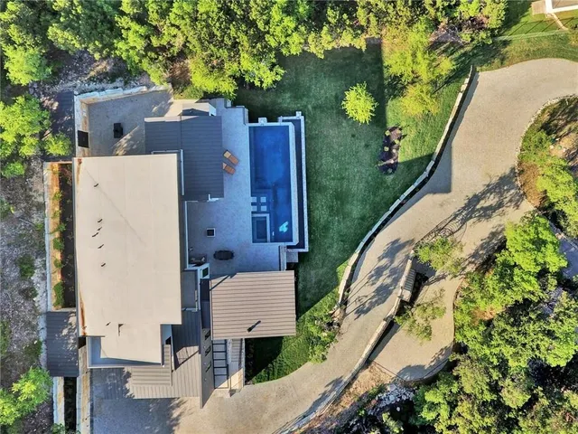 an aerial view of a house with a yard