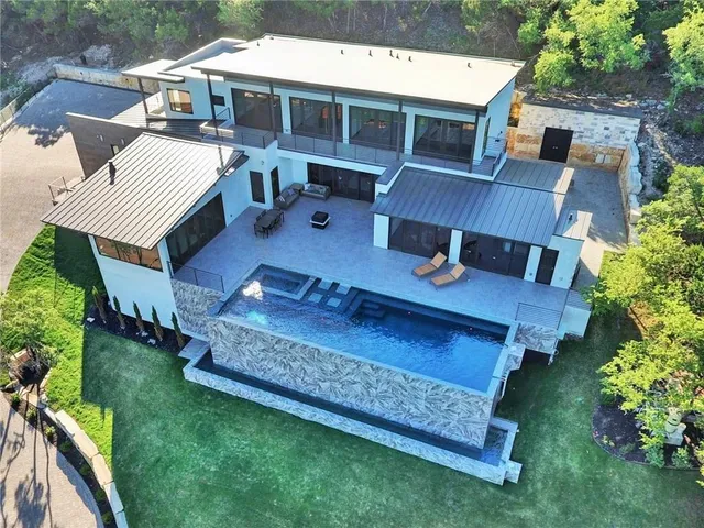 a view of a house with a yard deck and sitting area