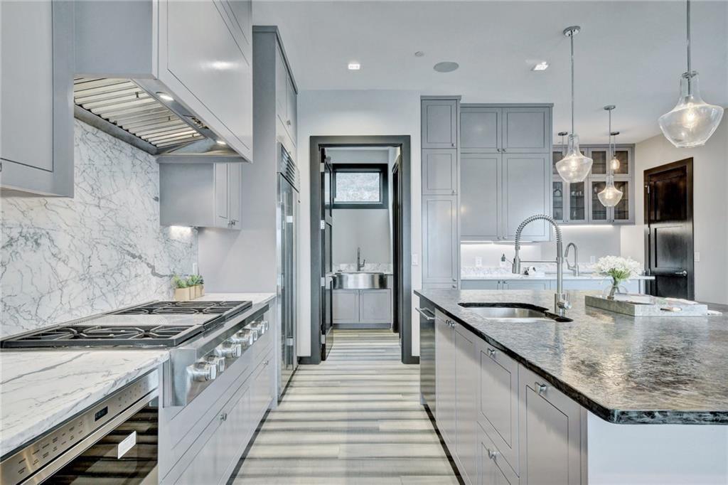 600 Barrett Lane Austin, TX 78733 - Photo 7 of 35 a kitchen with granite countertop a sink stove and refrigerator