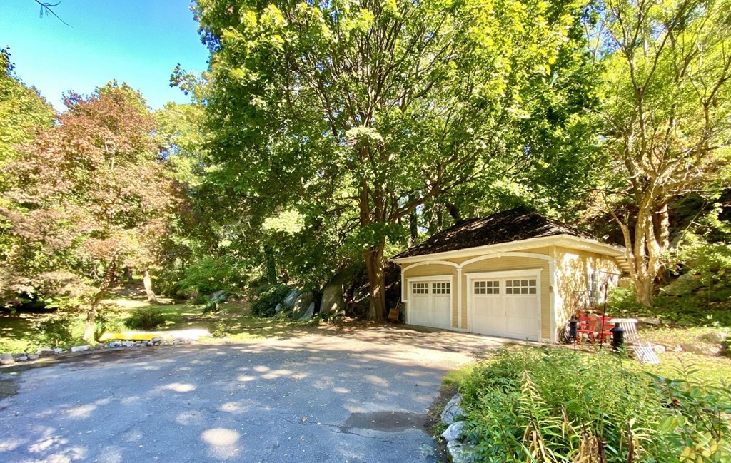 75 Bridge Street Manchester, MA 01944 - Photo 21 of 23 a front view of a house with a yard and garage