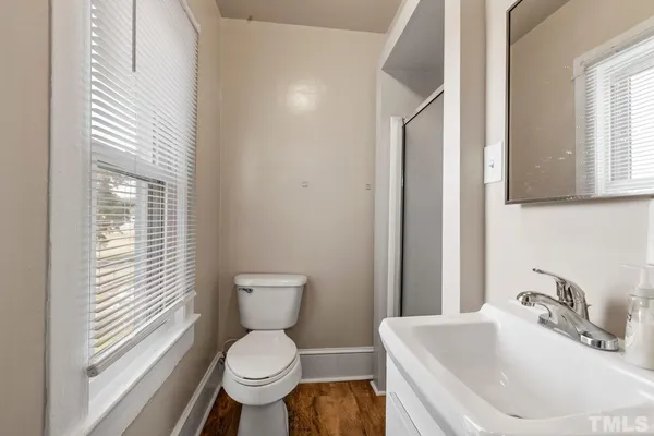 a bathroom with a toilet sink and a mirror