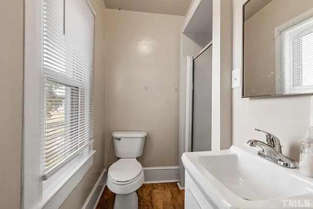a bathroom with a toilet sink and a mirror
