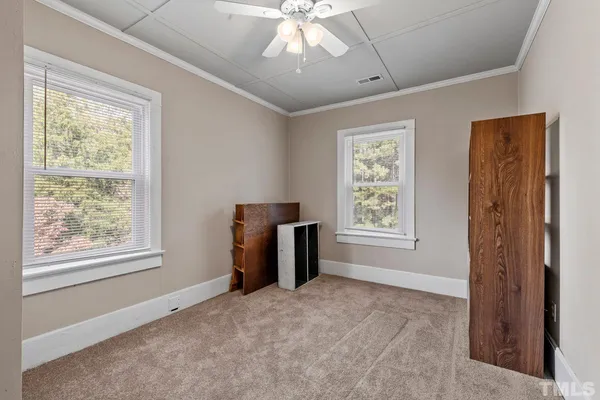 a view of livingroom with window closet and chandelier fan