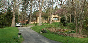 a front view of a house with a yard and fountain