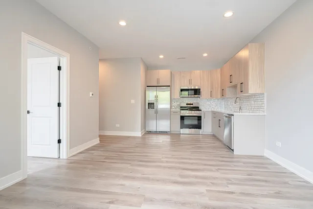 a view of kitchen with wooden floor