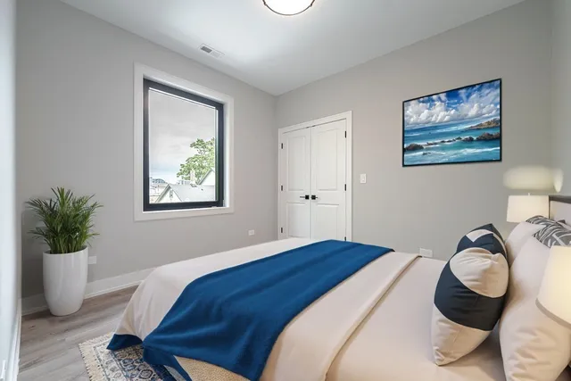 a bedroom with a bed and glass windows