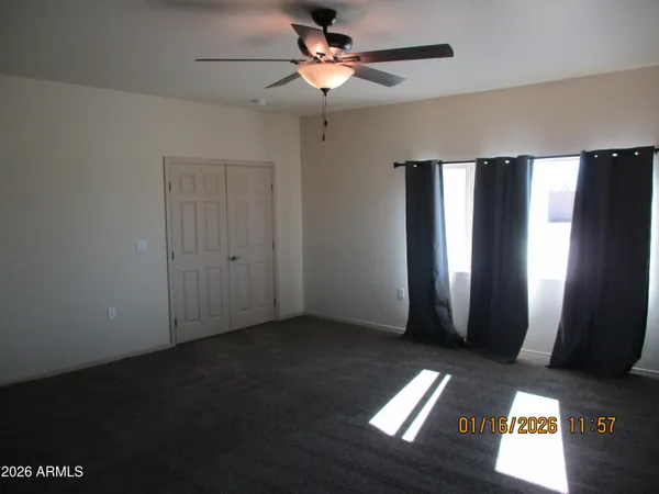 a view of a livingroom with a chandelier fan