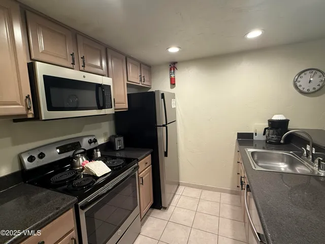 a kitchen with a sink appliances and cabinets