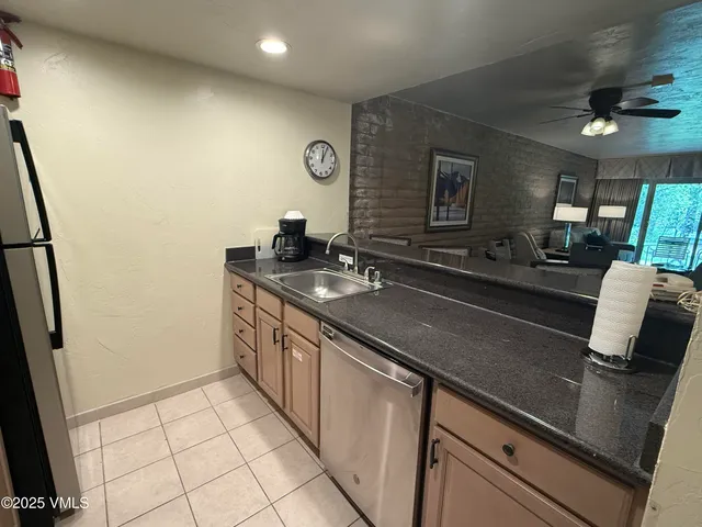 a kitchen with stainless steel appliances a sink stove and cabinets