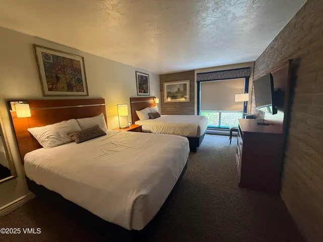 a bed room with a bed and a night stand