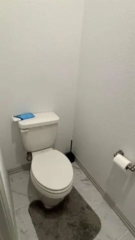 a white toilet sitting next to a white sink