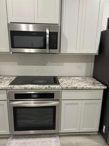 a stove top oven sitting inside of a kitchen
