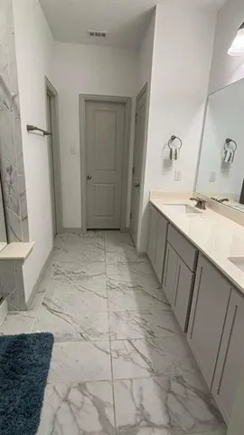 a bathroom with a sink a toilet and a mirror