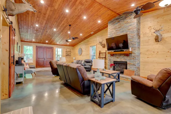 a living room with fireplace furniture and a flat screen tv