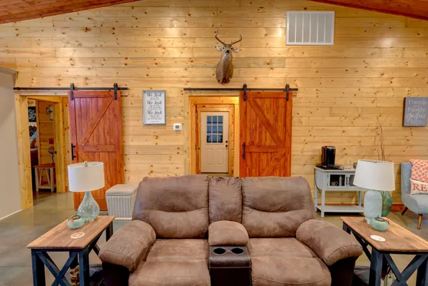 a living room with furniture a dining table and a fireplace