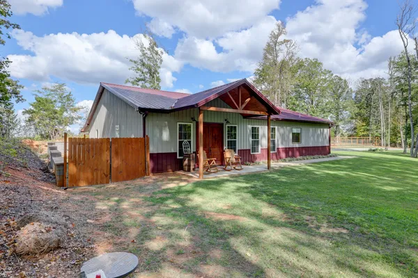 a view of a house with a yard porch and sitting area