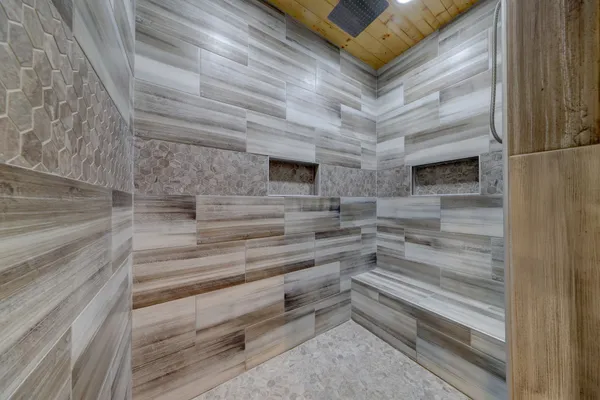 a bathroom with a granite countertop toilet sink and mirror
