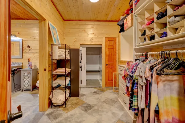 a view of a patio with a table and chairs under an umbrella with potted plants
