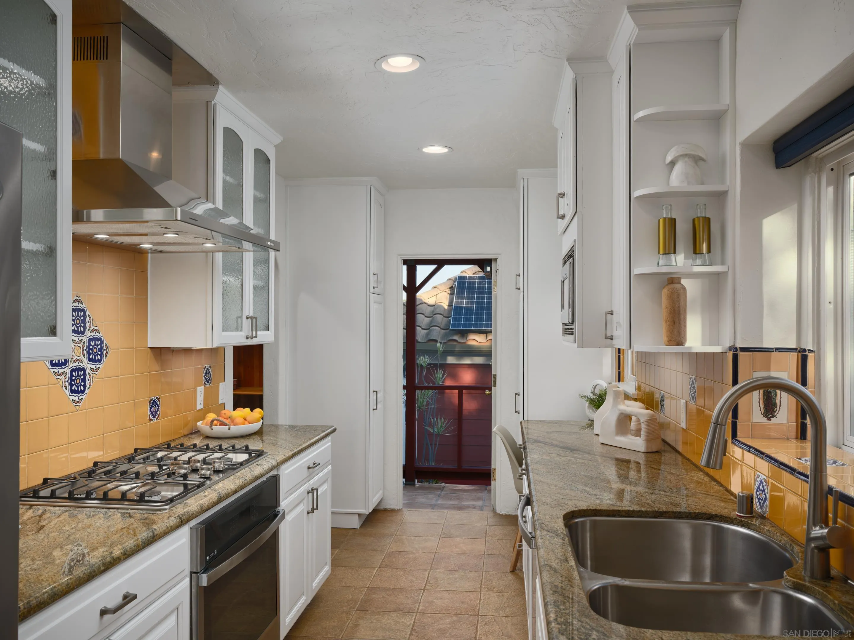4725 Natalie Drive San Diego, CA 92115 - Photo 14 of 34 a kitchen with stainless steel appliances granite countertop a sink stove and refrigerator