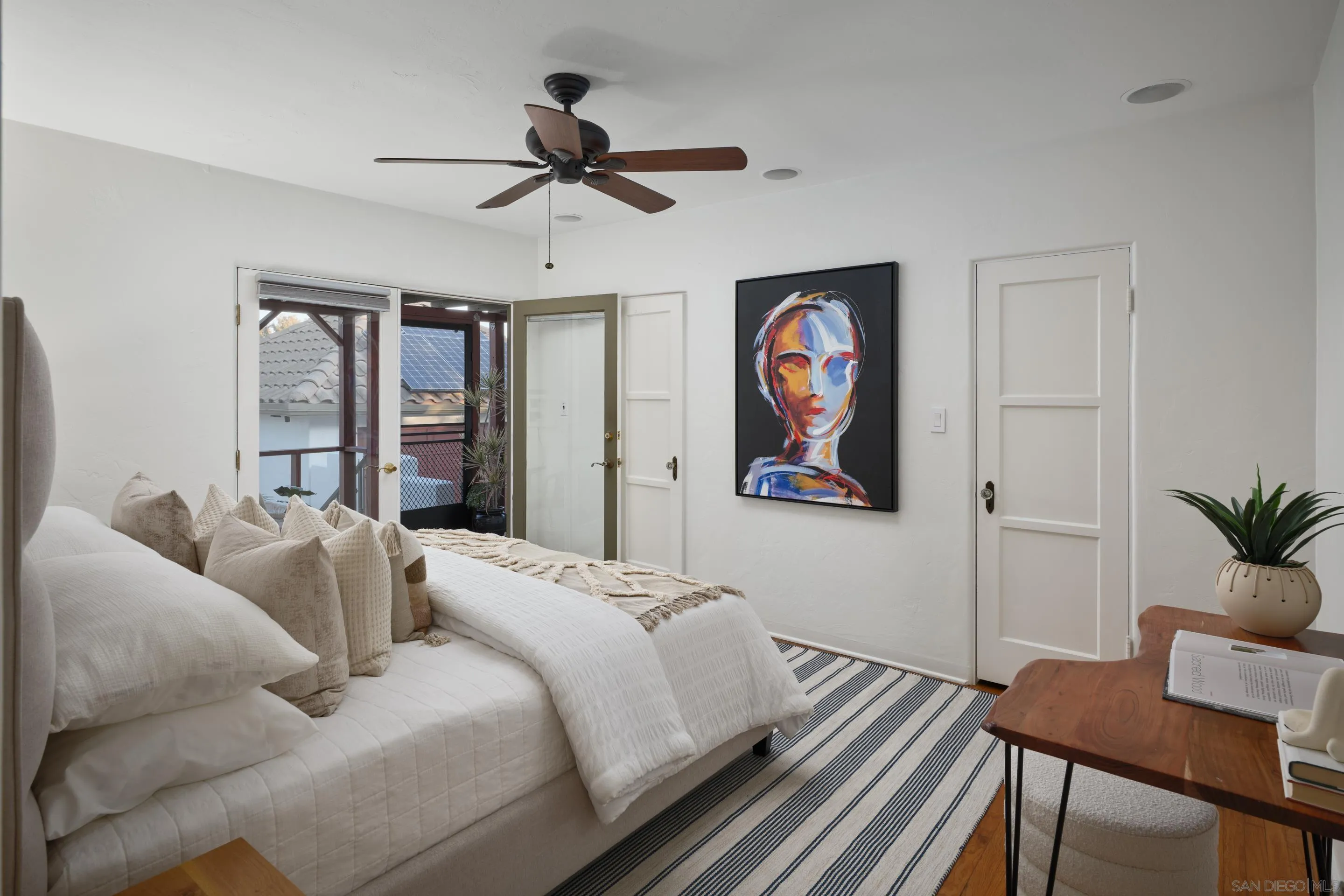 4725 Natalie Drive San Diego, CA 92115 - Photo 30 of 34 a bedroom with a bed and a chandelier