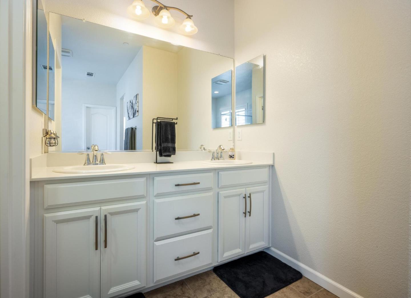 7708 Sumac Place Gilroy, CA 95020 - Photo 19 of 26 a bathroom with a sink and a mirror