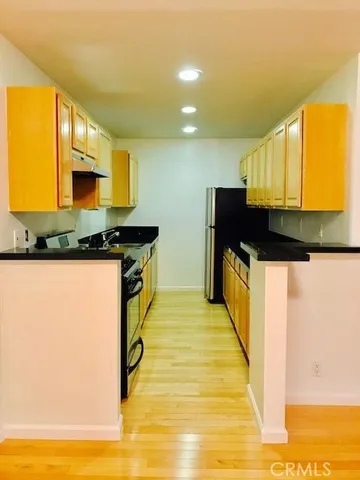 a kitchen with stainless steel appliances granite countertop a sink and cabinets