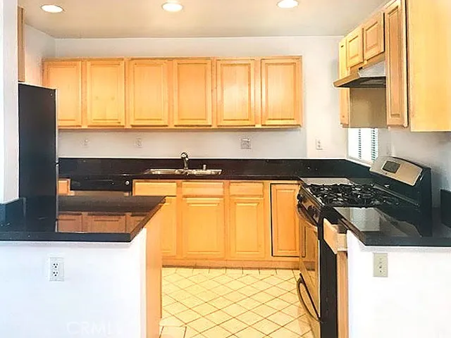 a kitchen with a sink a stove and a refrigerator